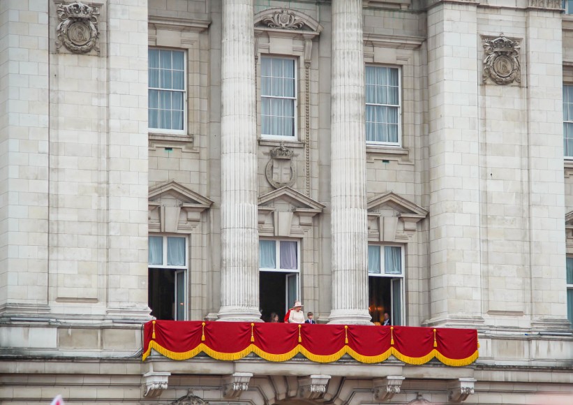 The Queen emerges on the balcony for the flypast. 